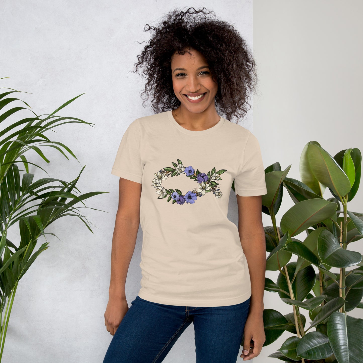 Female model wearing the Fish In Bloom unisex t-shirt in Soft Cream.